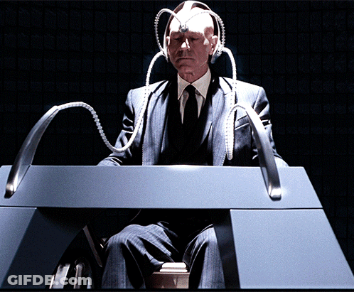 Man In Suit Sitting At Desk With Head Device GIF