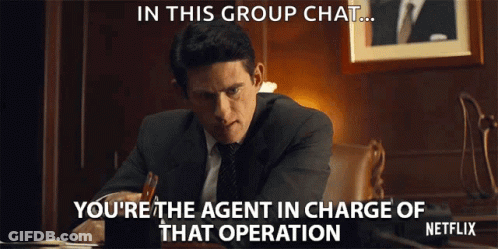 Man In Suit Sitting At Desk With Netflix Logo GIF