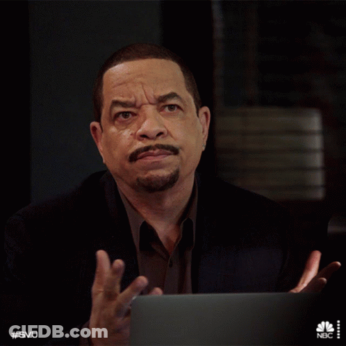 Man In Suit Sitting At Laptop With NBC Logo GIF