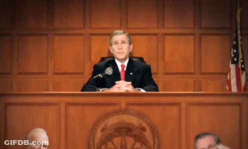 Man In Suit Sitting At Microphone GIF