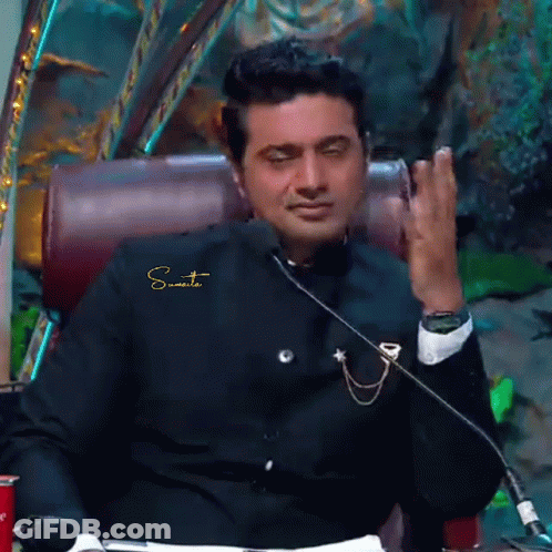 Man In Suit Sitting At Microphone Sumit GIF