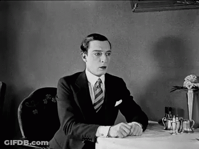 Man In Suit Sitting At Restaurant Table GIF
