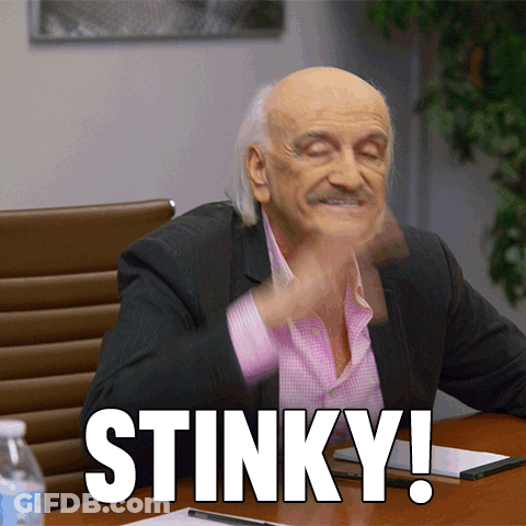 Man In Suit Sitting At Stinky Table GIF