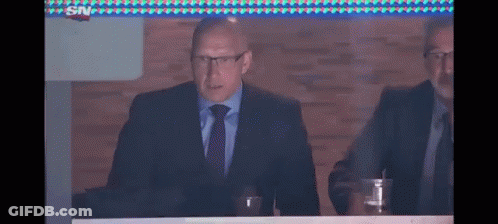 Man In Suit Sitting At Table GIF