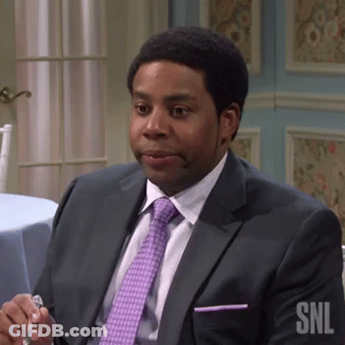 Man In Suit Sitting At Table Holding Glass GIF
