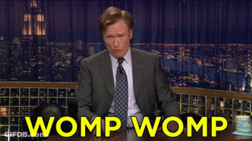Man In Suit Sitting At Table Saying Womp Womp GIF