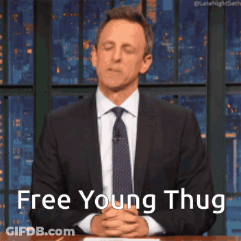 Man In Suit Sitting At Table Says Free Young Thug GIF