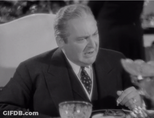 Man In Suit Sitting At Table With Bowl Of Food GIF