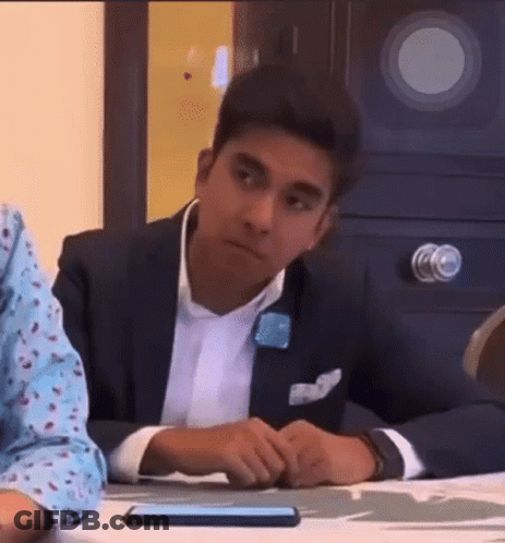 Man In Suit Sitting At Table With Hands Folded GIF