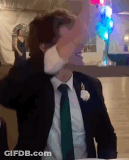 Man In Suit Sitting At Table With Hands On Head GIF