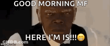 Man In Suit Sitting At Table With Homo Things Sign GIF