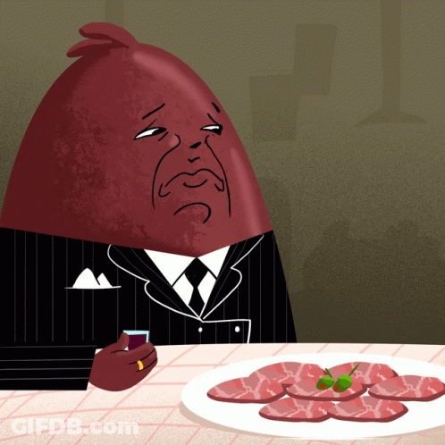 Man In Suit Sitting At Table With Meat GIF
