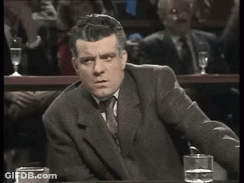 Man In Suit Sitting At Table With Water GIF