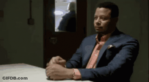Man In Suit Sitting At Table GIF
