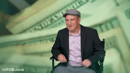Man In Suit Sitting Before Money GIF