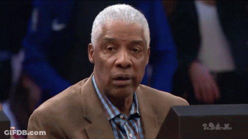Man In Suit Sitting Before PSA Sign GIF