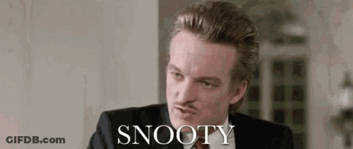 Man In Suit Sitting Before Snooty Wall GIF
