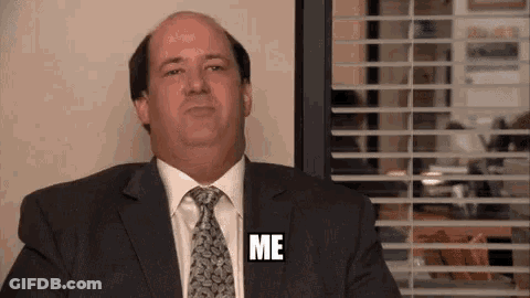 Man In Suit Sitting By Window Saying Me GIF