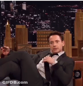 Man In Suit Sitting Cross-Legged GIF