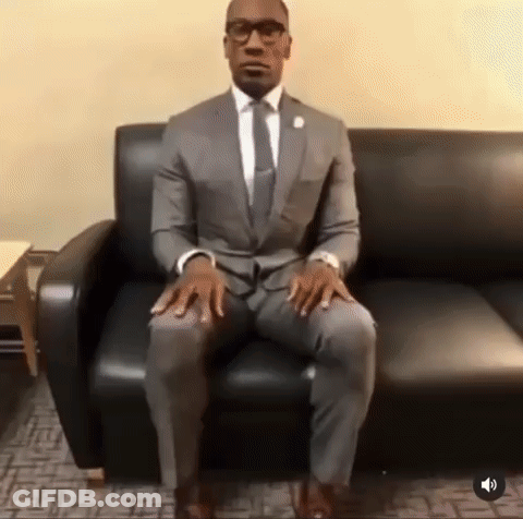 Man In Suit Sitting Crossed Legs GIF