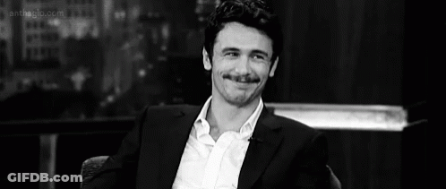 Man In Suit Sitting GIF