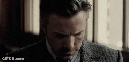 Man In Suit Sitting Eyes Closed By Window GIF