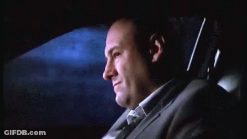 Man In Suit Sitting In Back Seat Of Car At Night GIF