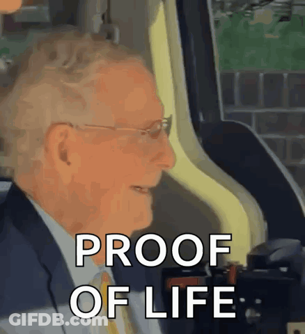 Man In Suit Sitting In Car Says Proof Of Life GIF