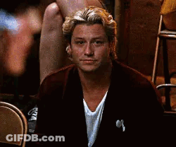 Man In Suit Sitting In Chair Looking At Camera GIF