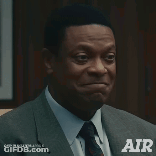 Man In Suit Sitting In Chair Saying Air GIF