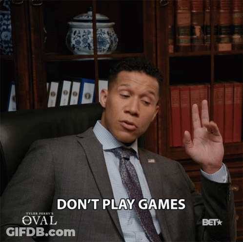 Man In Suit Sitting In Chair Saying Don't Play Games GIF