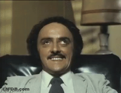Man In Suit Sitting In Chair Smiling Eyes Closed GIF