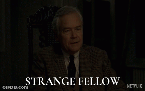Man In Suit Sitting In Chair Strange Fellow Netflix GIF