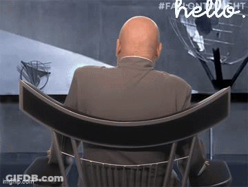 Man In Suit Sitting In Chair With Hello On Bottom GIF