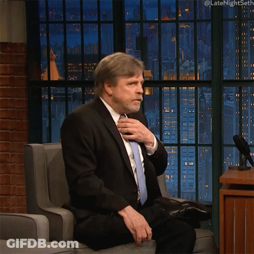 Man In Suit Sitting In Chair With Mouth Open GIF