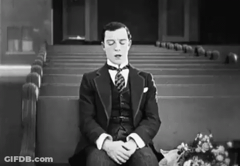 Man In Suit Sitting In Church Eyes Closed GIF