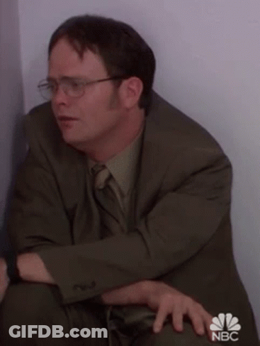 Man In Suit Sitting In Corner GIF
