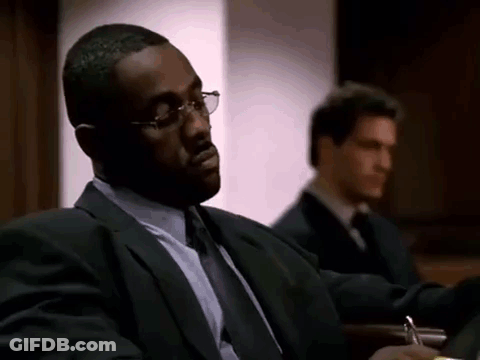 Man In Suit Sitting In Courtroom With Another Man GIF