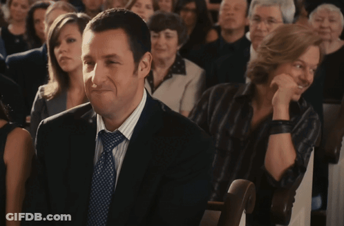 Man In Suit Sitting In Crowd GIF