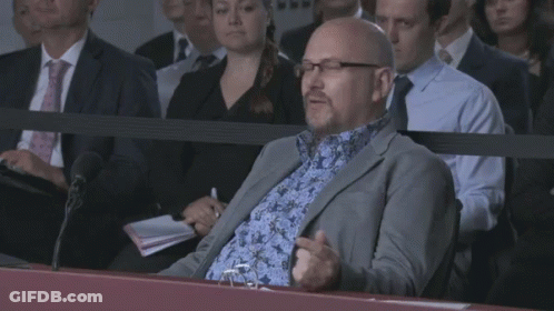 Man In Suit Sitting In Crowd Saying I'm Just A Lad GIF