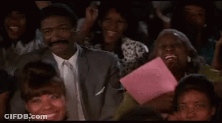 Man In Suit Sitting In Crowd Watching Show GIF