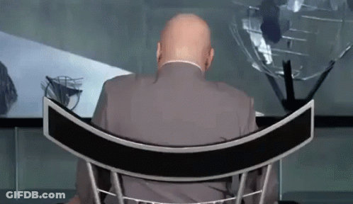 Man In Suit Sitting In Curved Chair GIF