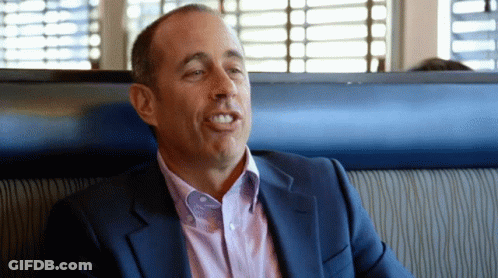 Man In Suit Sitting In Diner Booth GIF