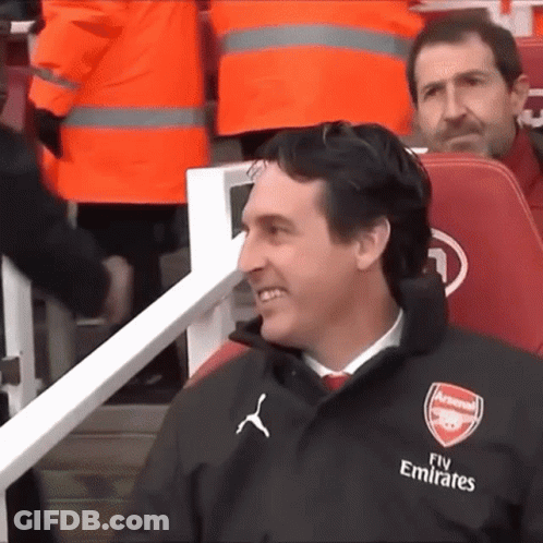 Man In Suit Sitting In Empty Stadium With Arsenal Media GIF