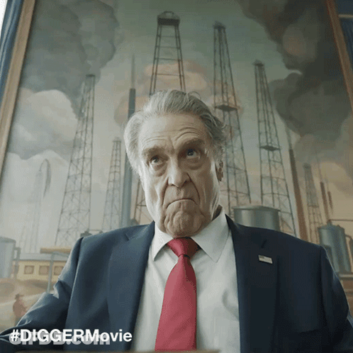 Man In Suit Sitting In Front Of #Diggermovie Painting GIF