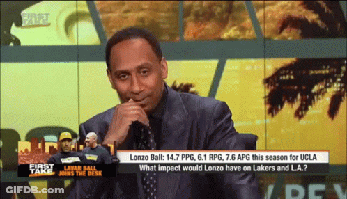 Man In Suit Sitting In Front Of First Take Screen GIF