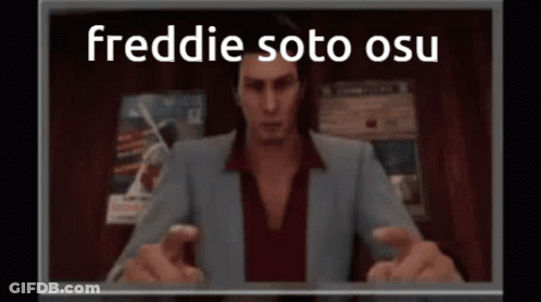 Man In Suit Sitting In Front Of Freddie Soto OSU Screen GIF