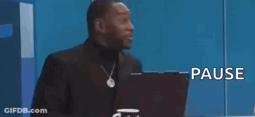 Man In Suit Sitting In Front Of Laptop Saying That Was Crazy Pause GIF