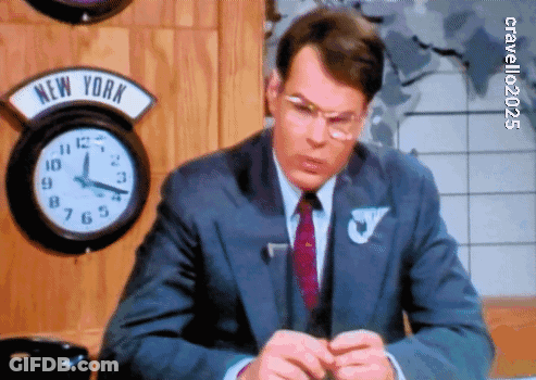 Man In Suit Sitting In Front Of New York Clock GIF