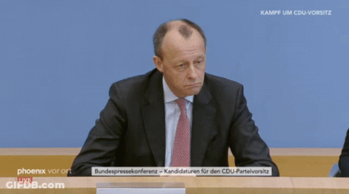 Man In Suit Sitting In Front Of Phoenix Vor Ort Live Screen GIF